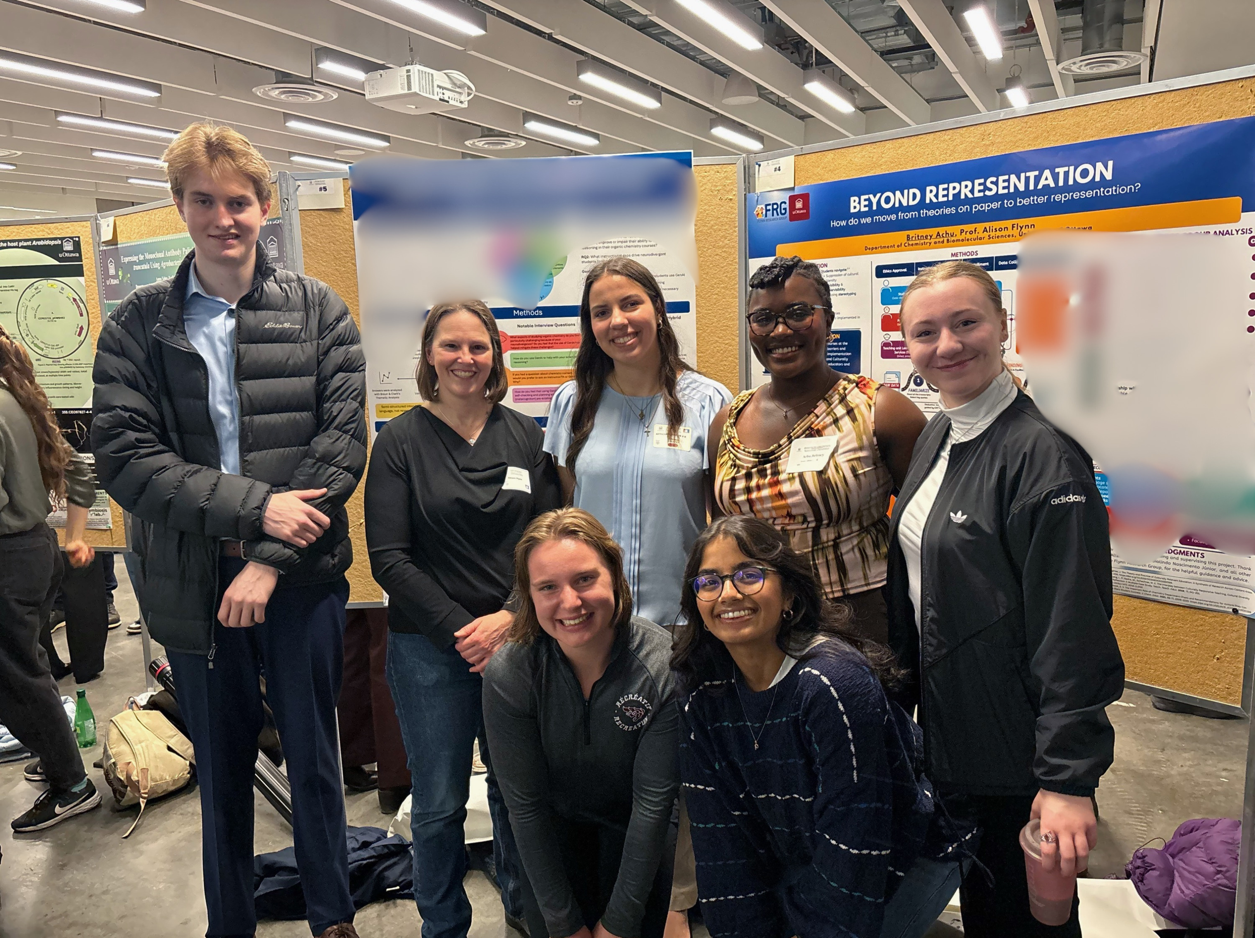 This image showing Dr. Flynn and group members supporting Britney, Olivia, and Dashiell during their posters' presentation.