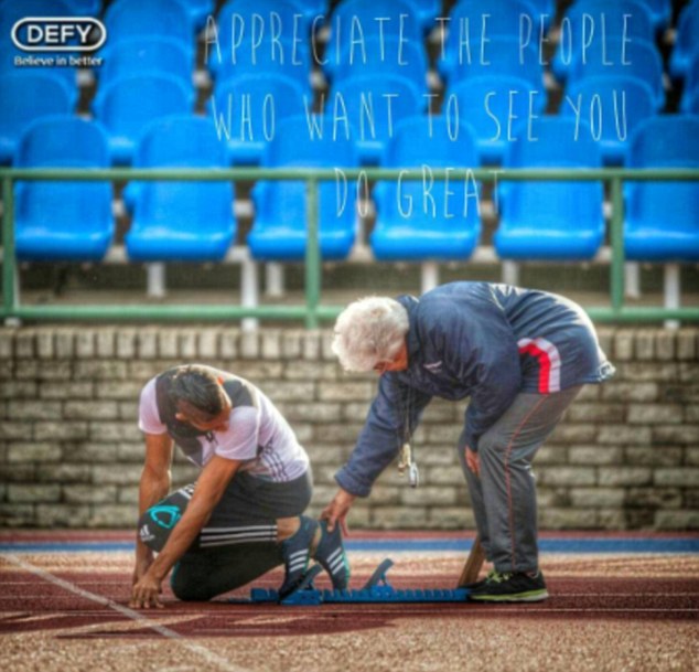Ans Botha, Wade van Niekerk's 74-year-old coach, helps him with the starting blocks.