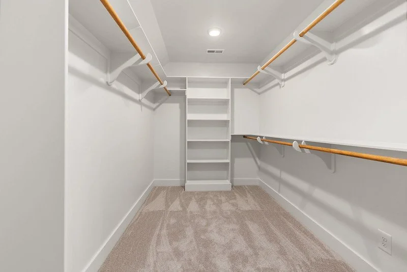 20 Primary Bedroom Walk In Closet Abundant Storage.jpg