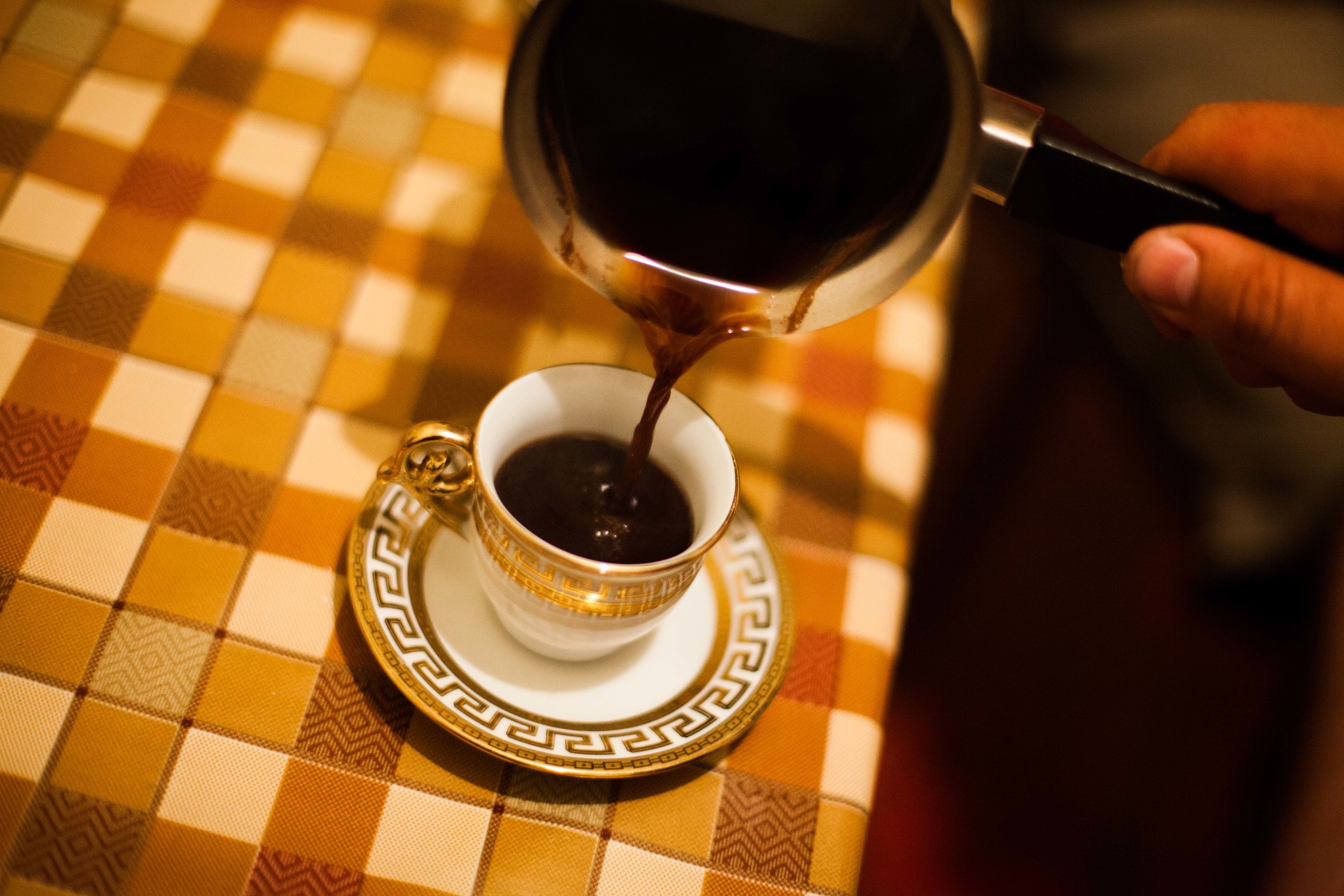 Small cups of strong black coffee are served multiple times throughout the day and are normally drank while socializing with friends.