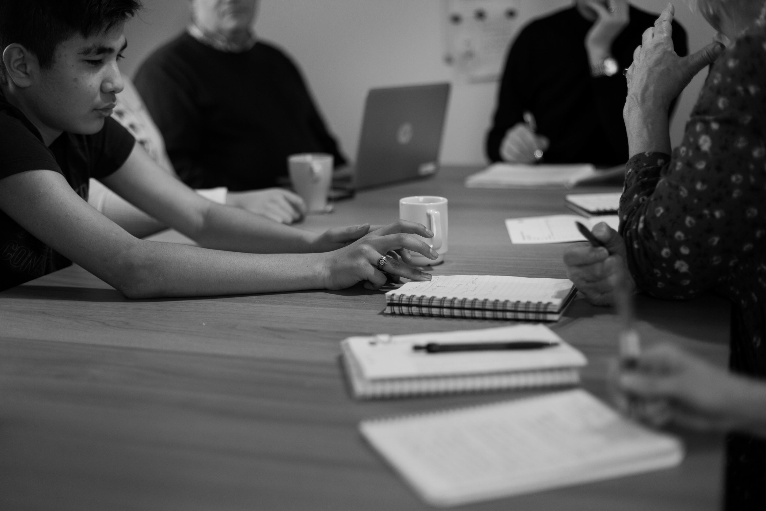 Hadi sits in a meeting with Annika, personnel from the group home, and teachers from his school to talk about his progress in the classroom and address any social issues he is facing. Part of the education promise in Sweden is that every student is
