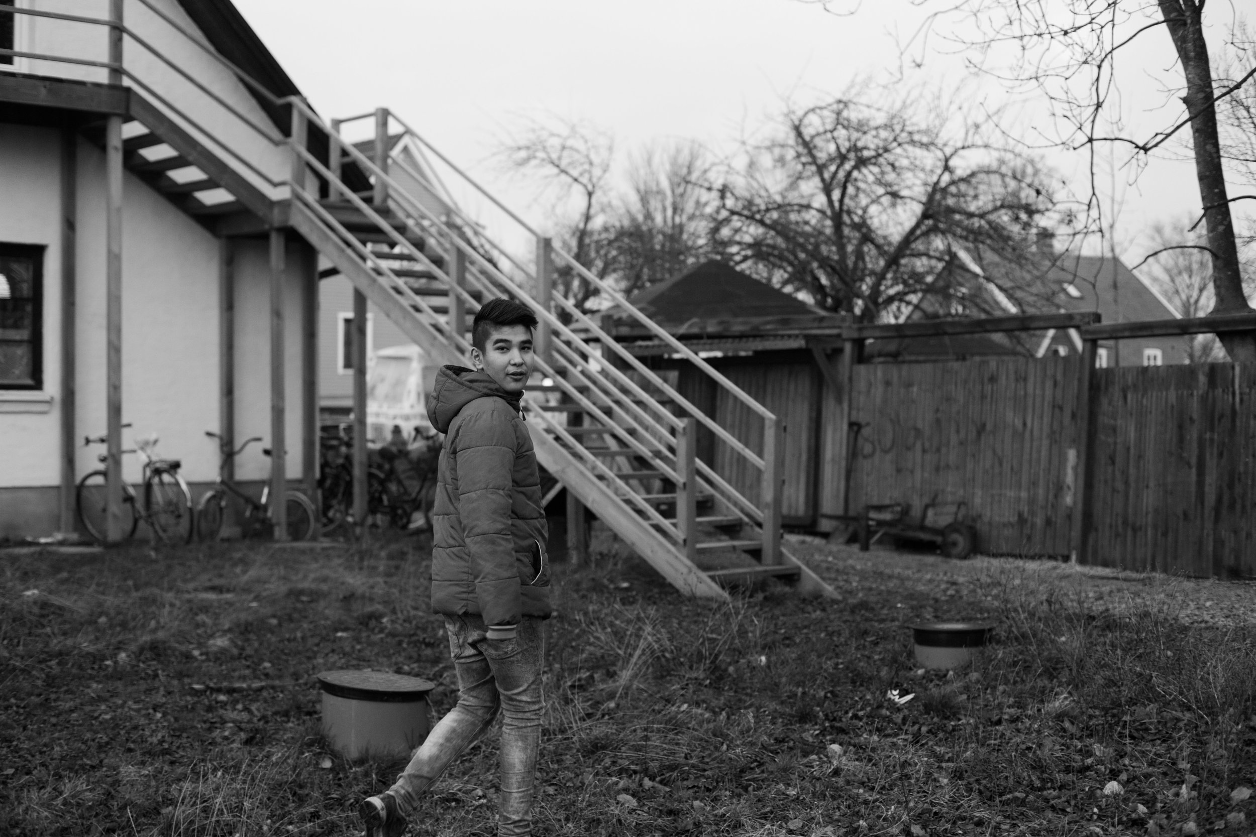 Mahdi spends time outside one of the first homes he lived in in Sweden. Because of the unprecedented number of refugees who arrived in 2015, the Swedish government had to rent out private houses to accommodate everyone who needed shelter. These faci