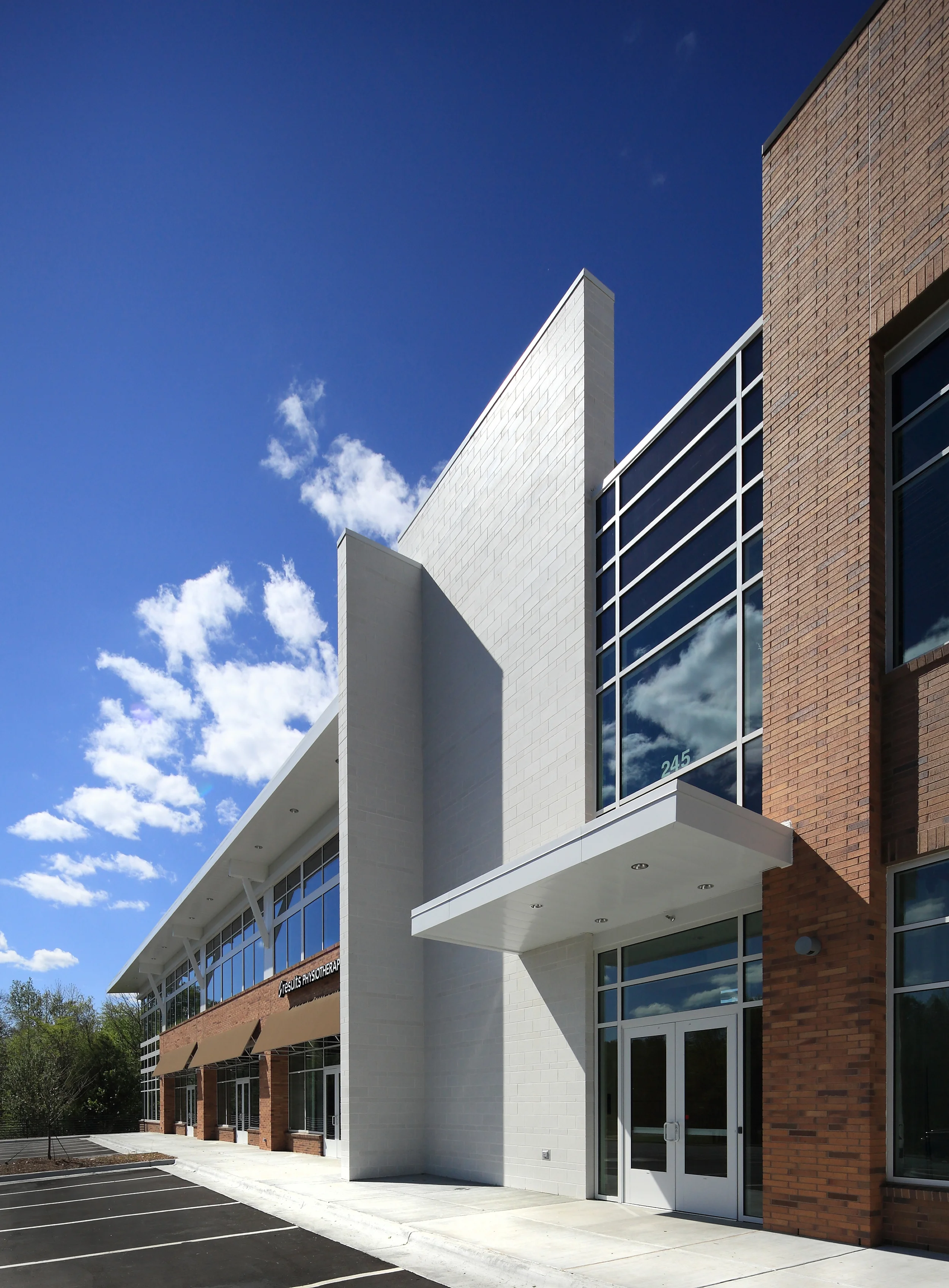   With tight site constraints from an adjacent stream buffer, the building maximizes it footprint with a unique angled corner which marks the main entry into the medical office campus.  