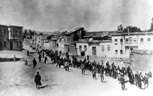 Ottoman Armenians are marched to a prison in Kharpert, Armenia, by armed Turkish soldiers in April 1915. Up to 1.5 million Armenians were killed in what is now recognized as the 20th century's first genocide. (PROJECT SAVE / NEW YORK TIMES)