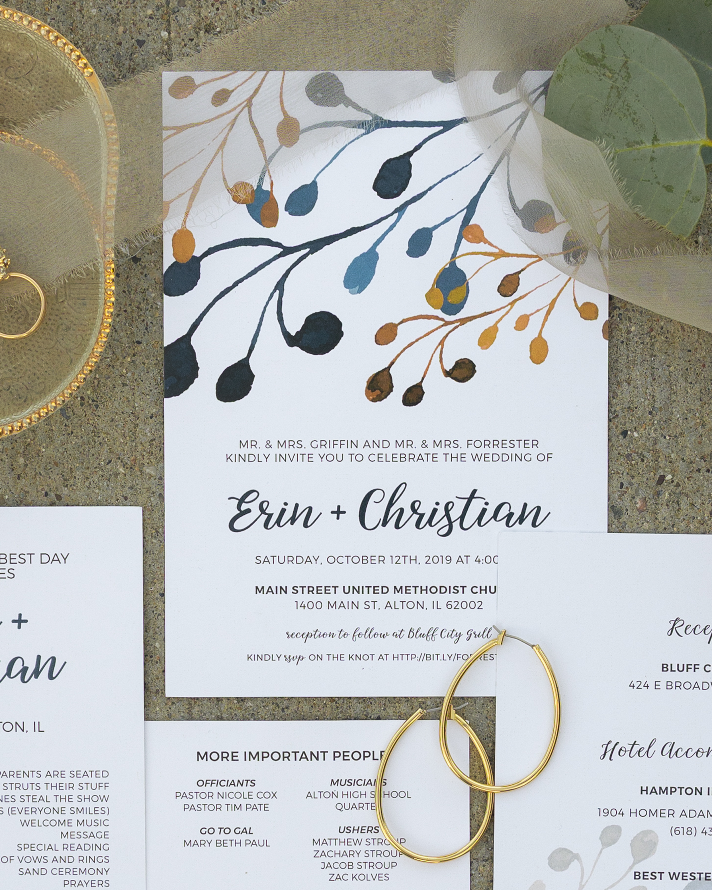 Wedding invitation for Erin and Christian, scheduled for Saturday, October 12, 2019, at 4:00 PM, at Main Street United Methodist Church, Alton, Illinois, with reception at Bluff City Grill, including decorative botanical graphics and gold jewelry on 