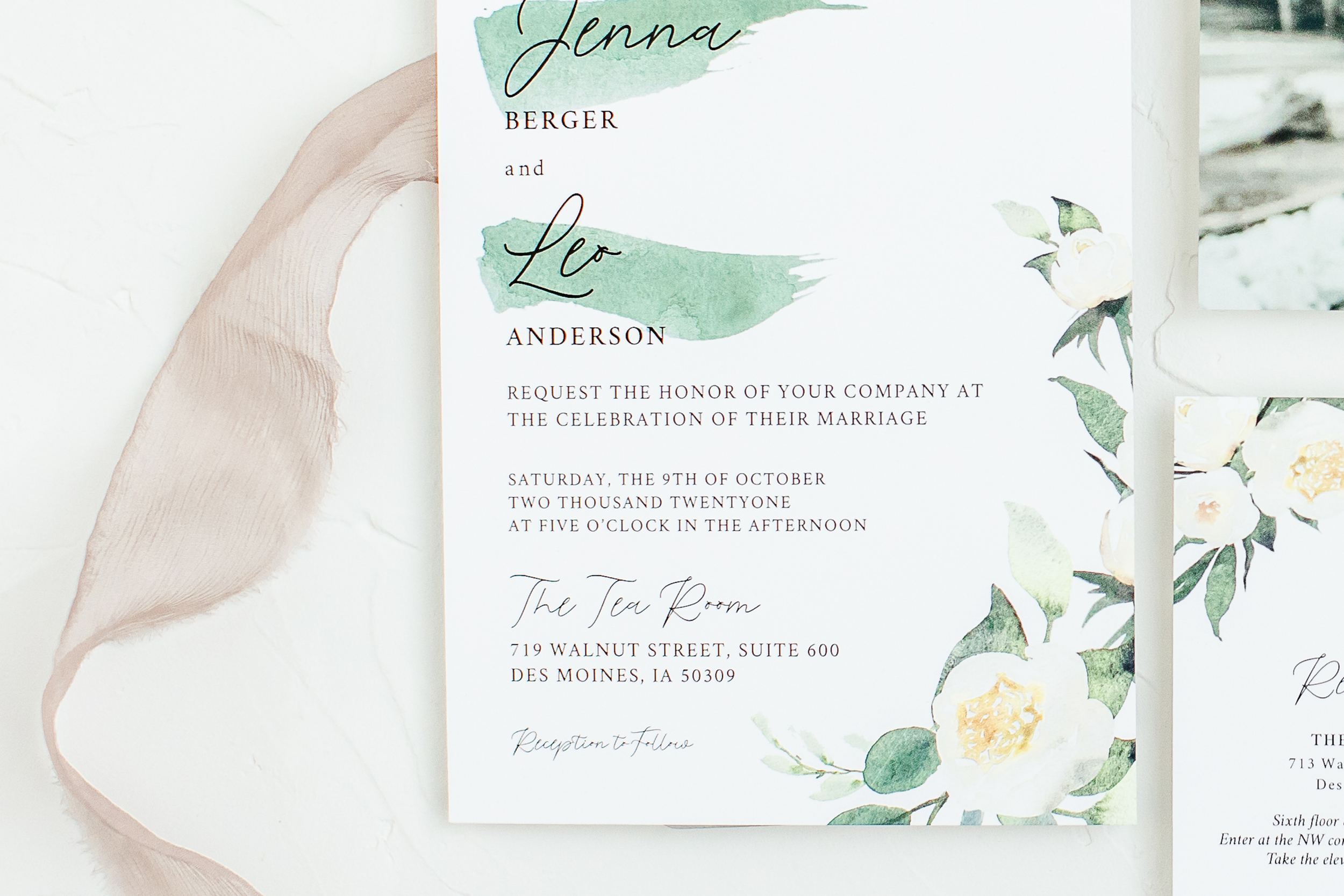 Wedding invitation with floral and watercolor design, featuring green leaves and white flowers. Text includes names 'Jenna Berger' and 'Léo Anderson,' with details about a marriage celebration on October 9th in Des Moines, Iowa.