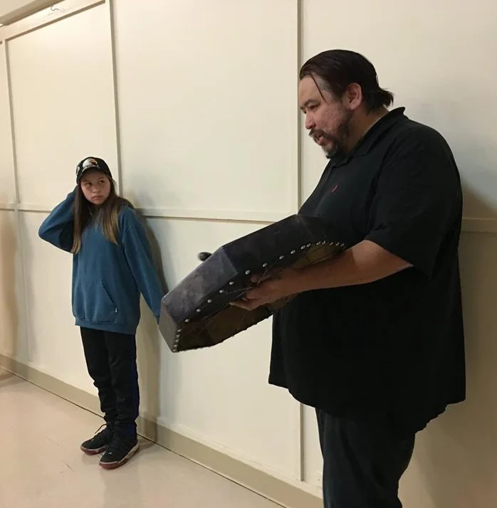 On the right, Tsumkwatun (Councilor Lawrence Mitchell, Snaw-naw-as First Nation) sings a song with his daughter (left) after hosting a meal for CBRA on behalf of the Nation.