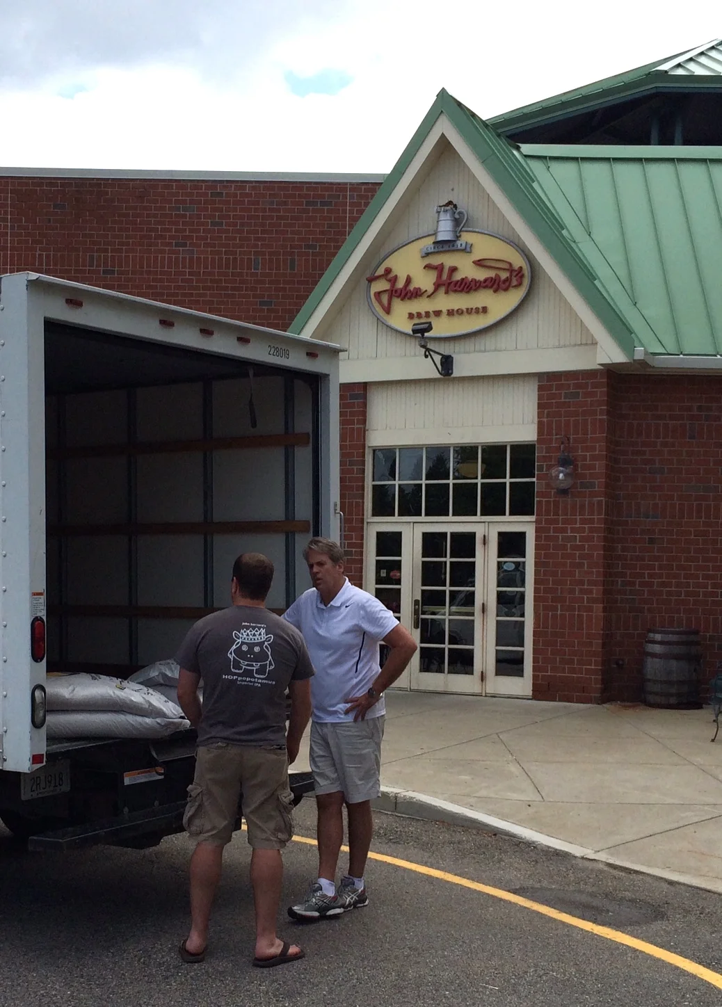 Aaron Crossett, Head Brewer, John Harvard's Brewery takes delivery from Mark