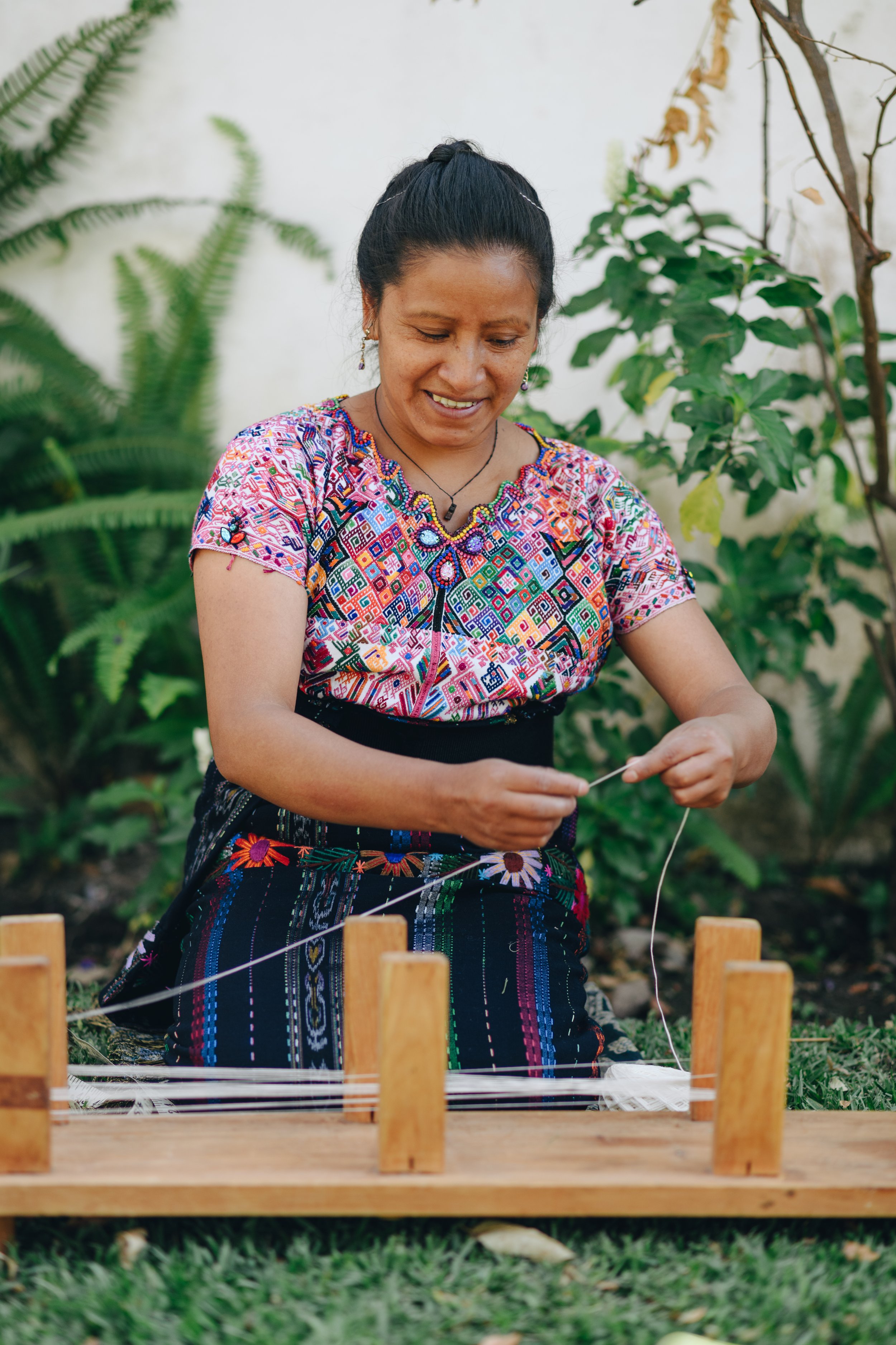 Backstrap weaver prepares threads for a custom design in Guatemala.