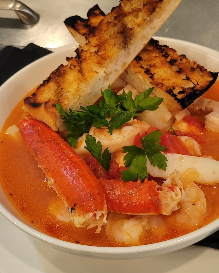 This weekend's seafood feature: Cioppino, swordfish, salmon, shrimp, calamari, snow crab, scallops, tomato - fennel seafood broth and grilled focaccia bread.