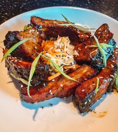 Have you tried our new summer starters: pictured here our Korean BBq baby back ribs with house made kimchi.