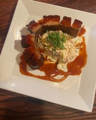 This Weeks featured Starter is smoked pork belly chicharrone w a chipotle - orange slaw and a orange - tequila BBQ glaze.