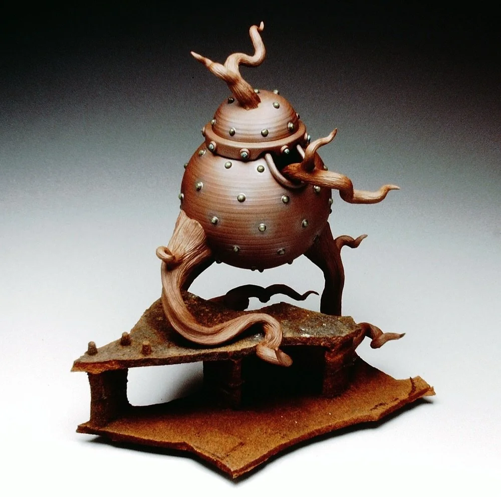 #throwbackthursday  Glazing and firing stuff this week so here&rsquo;s a jar with spoon I made late 90s ish. I liked how it relied on the chunk of rusted metal in order to sit level (tripod), like an octopus moving over an uneven sea floor 🐙 
.
.
.
