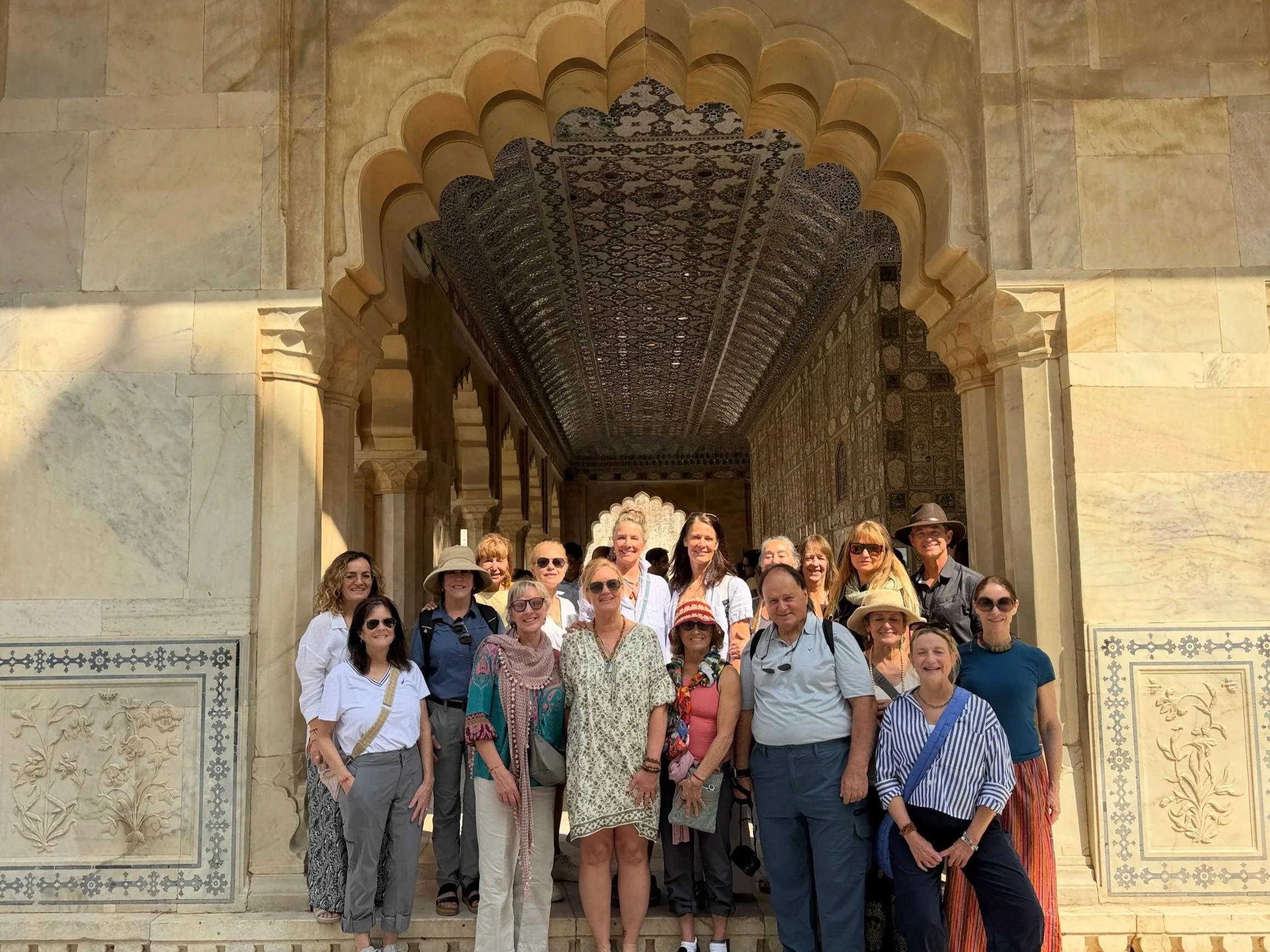 Outer Banks Yoga retreat group standing together in front of traditional architecture during a yoga retreat in India