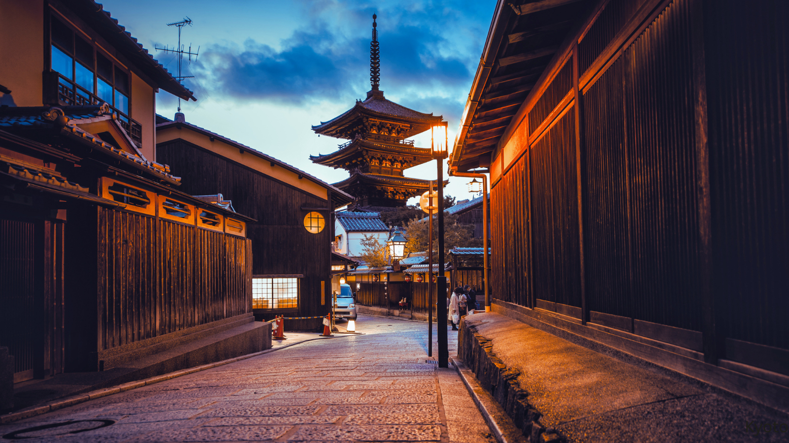 Traditional Kyoto street and illuminated pagoda at night, showcasing the spiritual and historic heart of Japan.