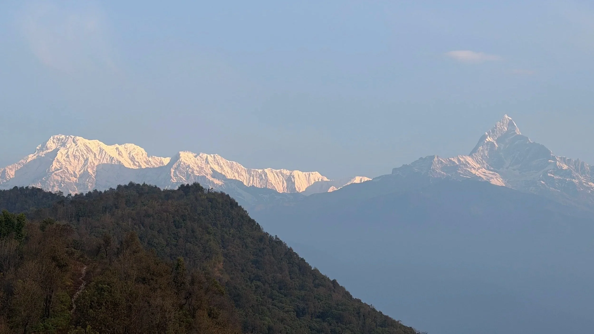 snow-capped peaks of the Himalayas glowing in the morning light during an Outer Banks Yoga international retreat.
