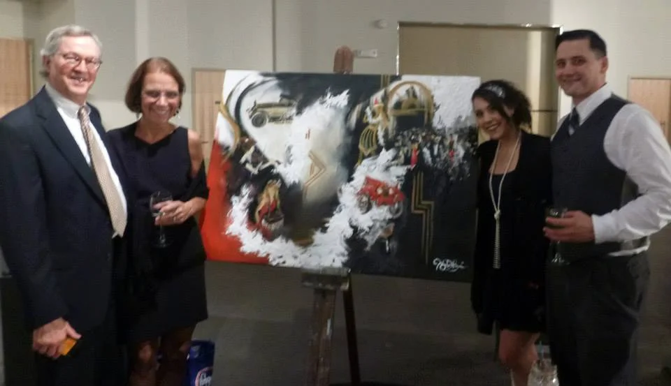 This is what the live event painting looked like at the end of the night, after just a few hours of painting. Here we are standing next to it with the winning bidders just after the live auction