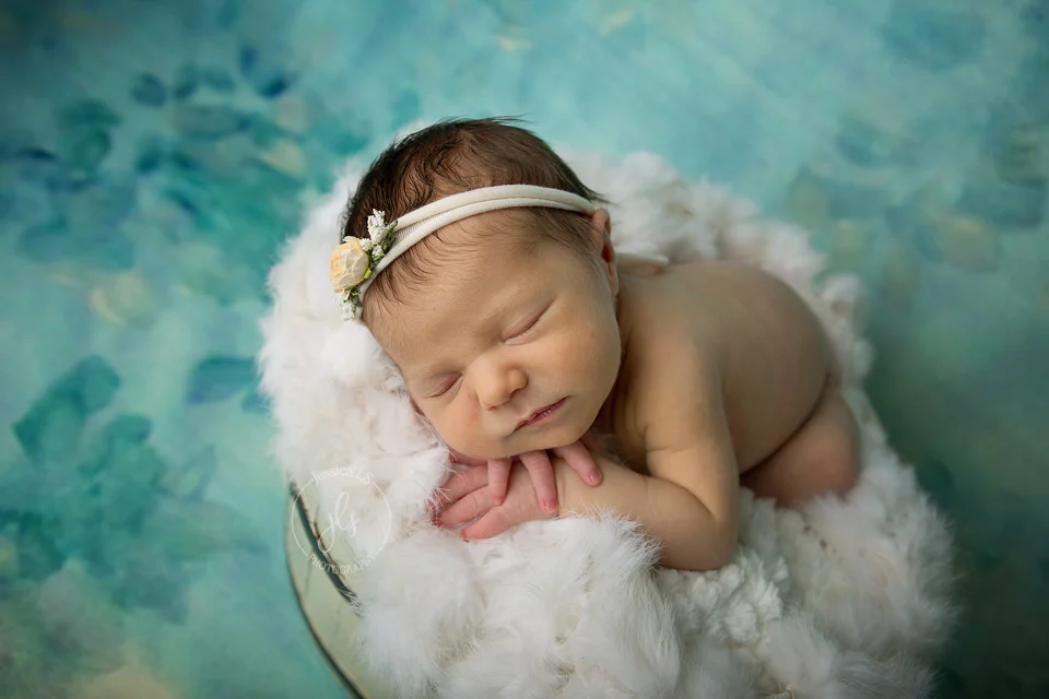 Newborn baby girl in bucket