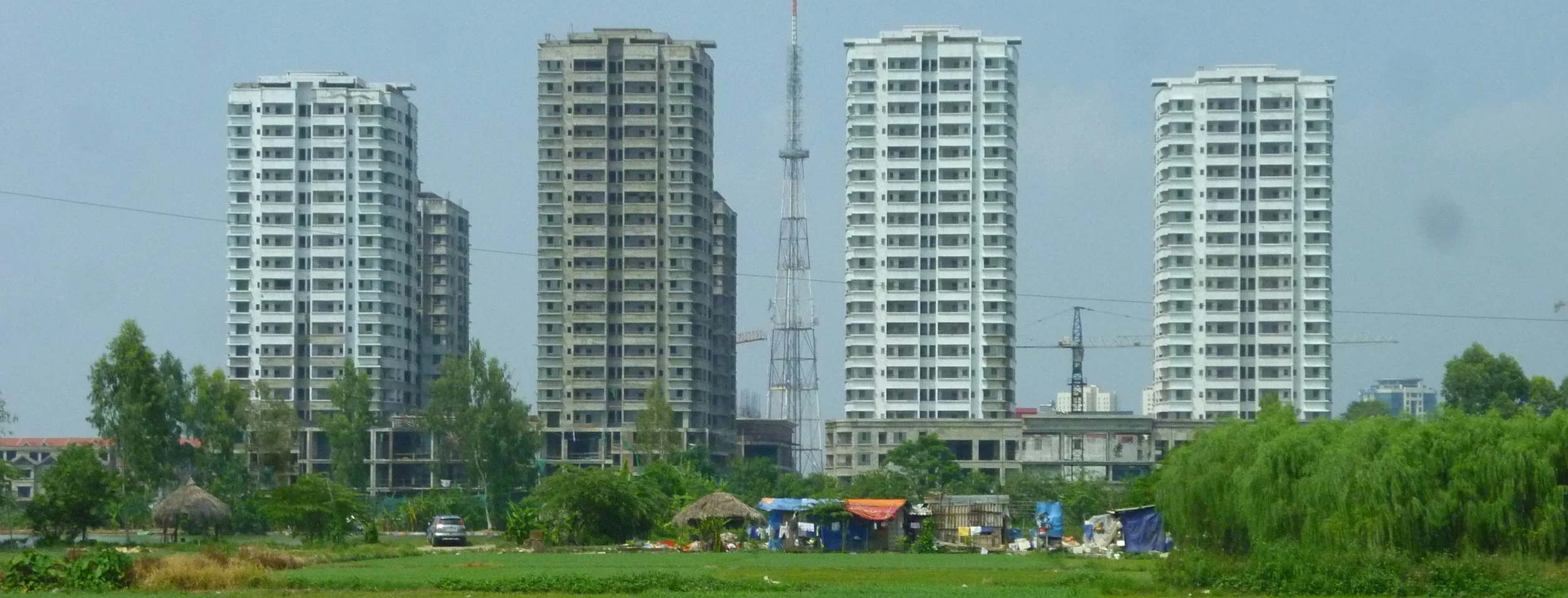 A new mixed-use development rises from the paddy fields on the periphery of Hanoi. Photo by Clément Musil (2012).