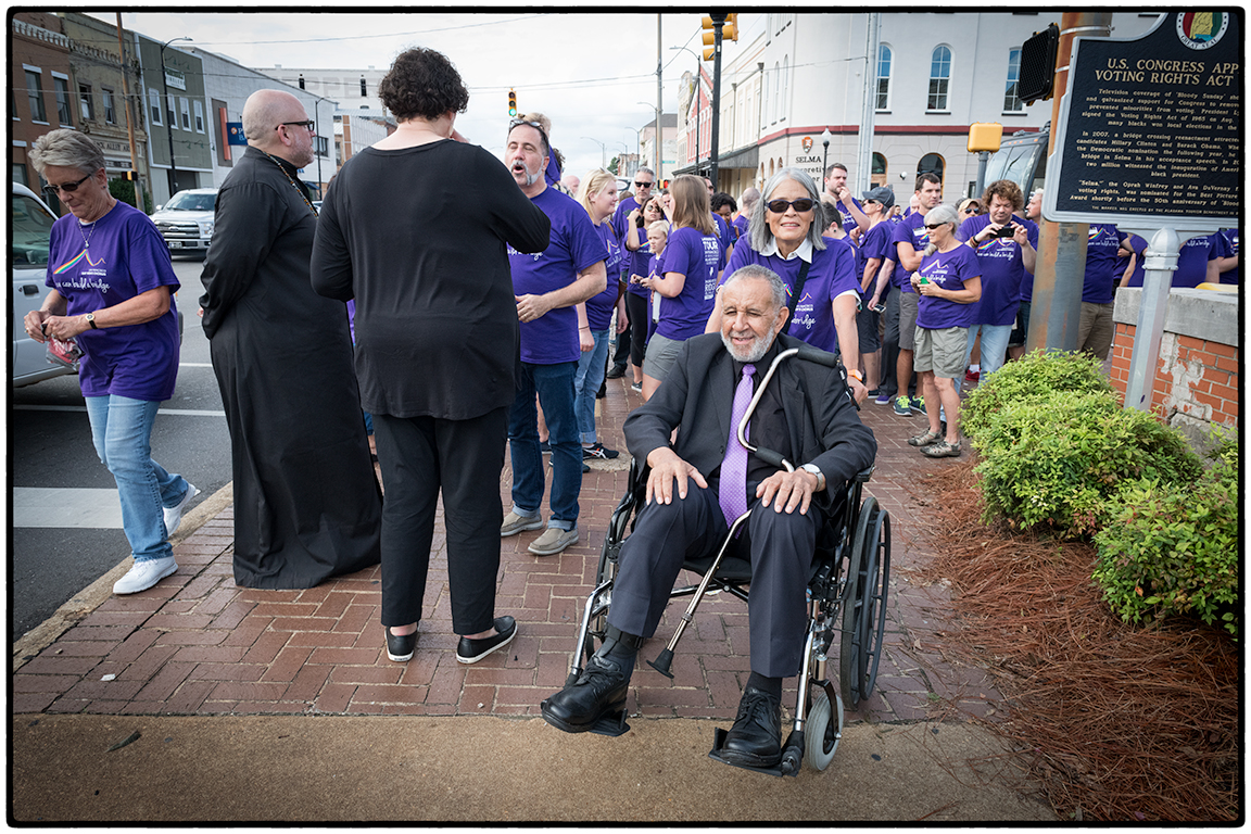 Jadyne escorting Gil, one of the original marchers, across the bridge