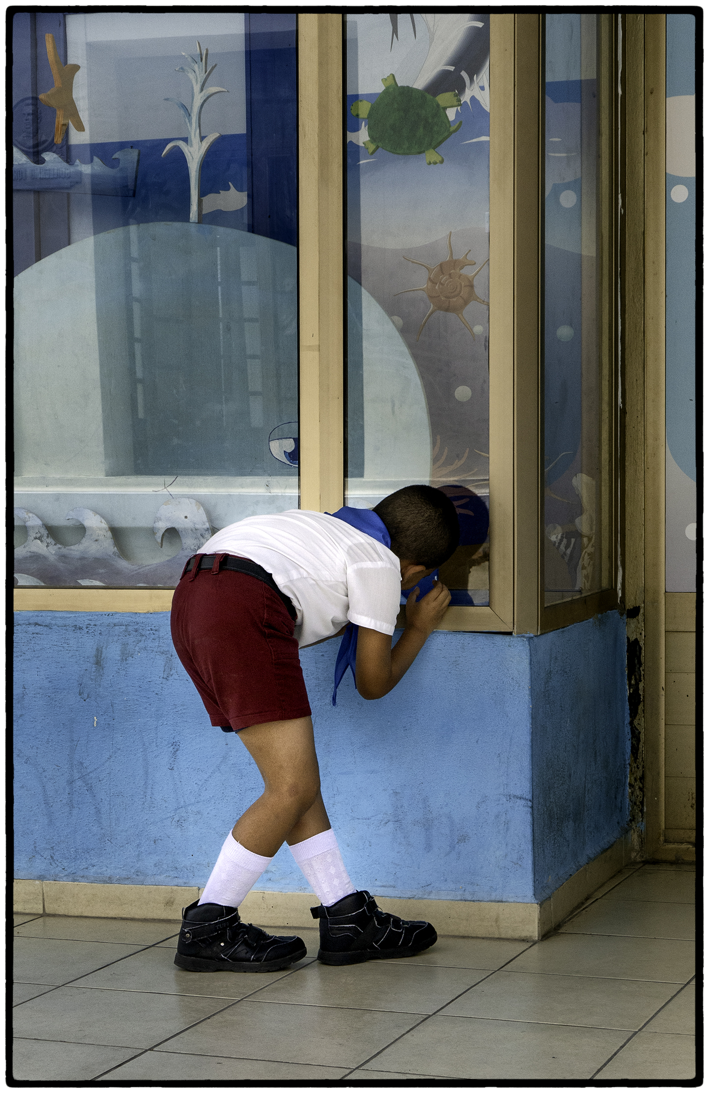 Elementary Student Peeking in Toy Store