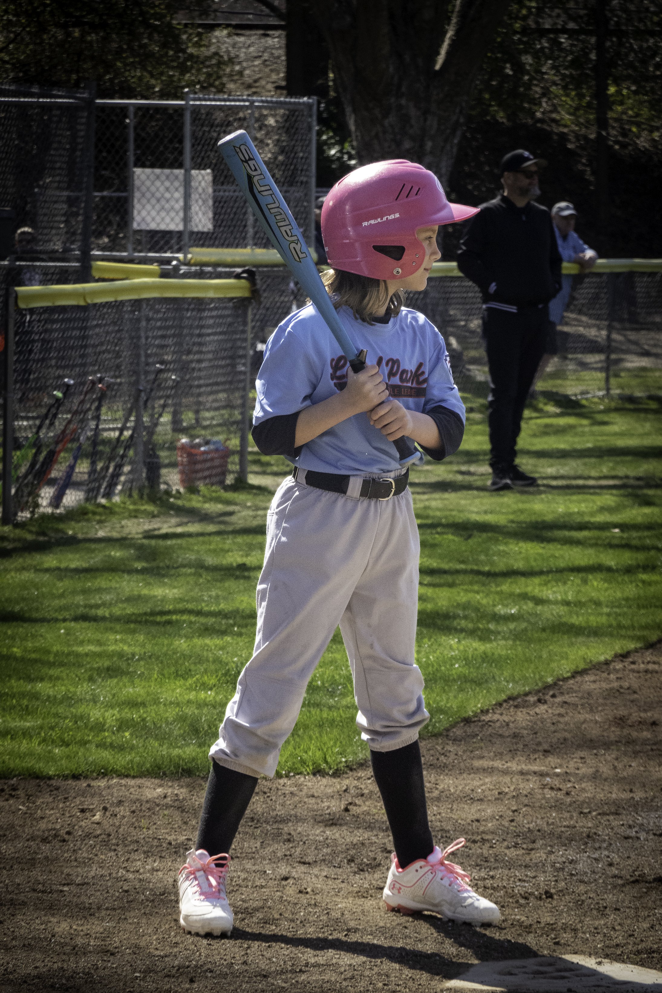 Matching helmet and shoestrings.  Matching bat and jersey.  Matching her teammates by striking out.