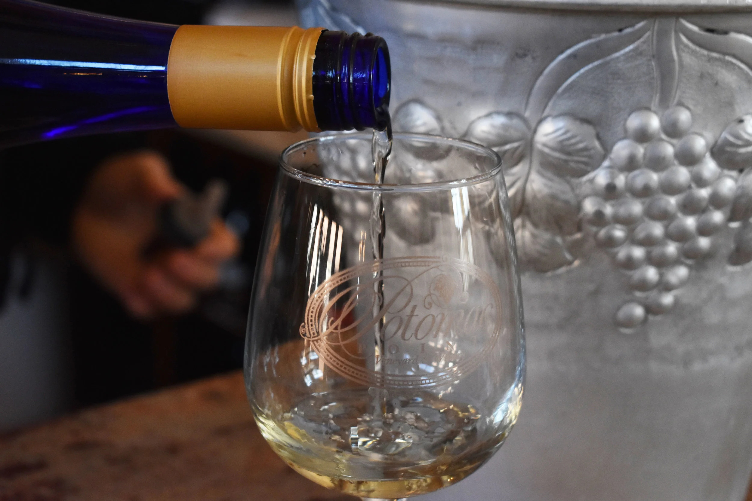 David Pagan Castaño, head winemaker at Potomac Point Vineyard and Winery in Stafford, Va., pours a glass of La Belle Vie in the tasting room, Friday, Feb. 2, 2018. Potomac Point says La Belle Vie is its most popular white wine. (Lindsey Leake/American University)