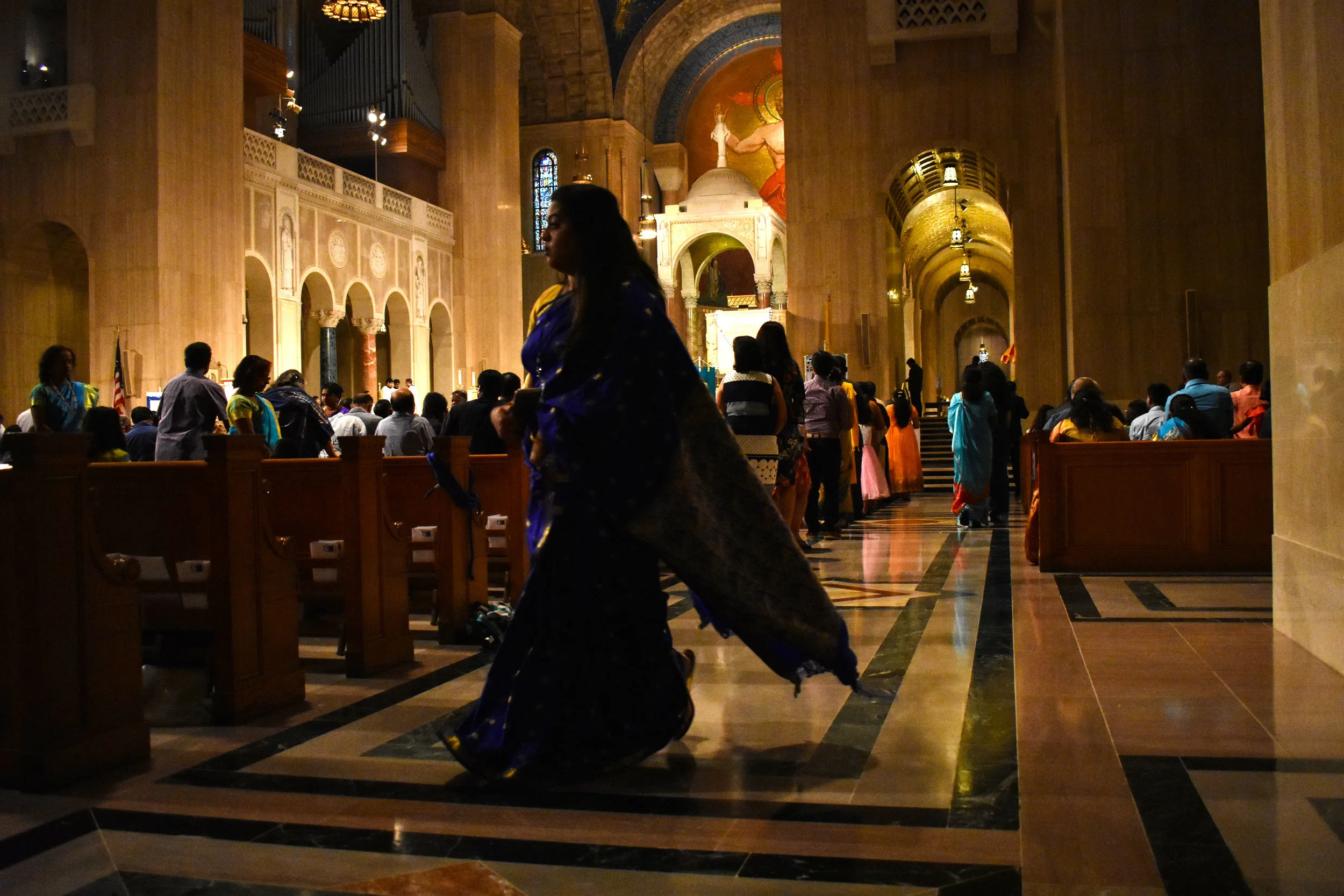 Jefreena Packianathan, vice president of the Indian American Catholic Association, walks across an aisle of the Upper Church at the Basilica of the National Shrine of the Immaculate Conception in Washington, Saturday, Sept. 8, 2018. Hundreds of Catholics of South Asian descent convened for IACA’s 21st Annual Pilgrimage to Our Lady of Good Health, Vailankanni. (Lindsey Leake/American University)