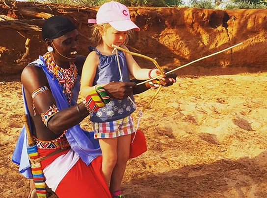  Farley's daughter learning archery from the Maasai&nbsp; 