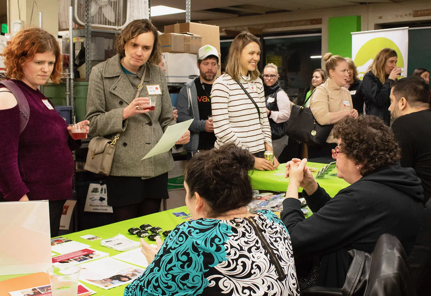 PDXWIT Happy Hour @ Free Geek, 11/27/18, Attendees meet with potential employers at our jobseekers table