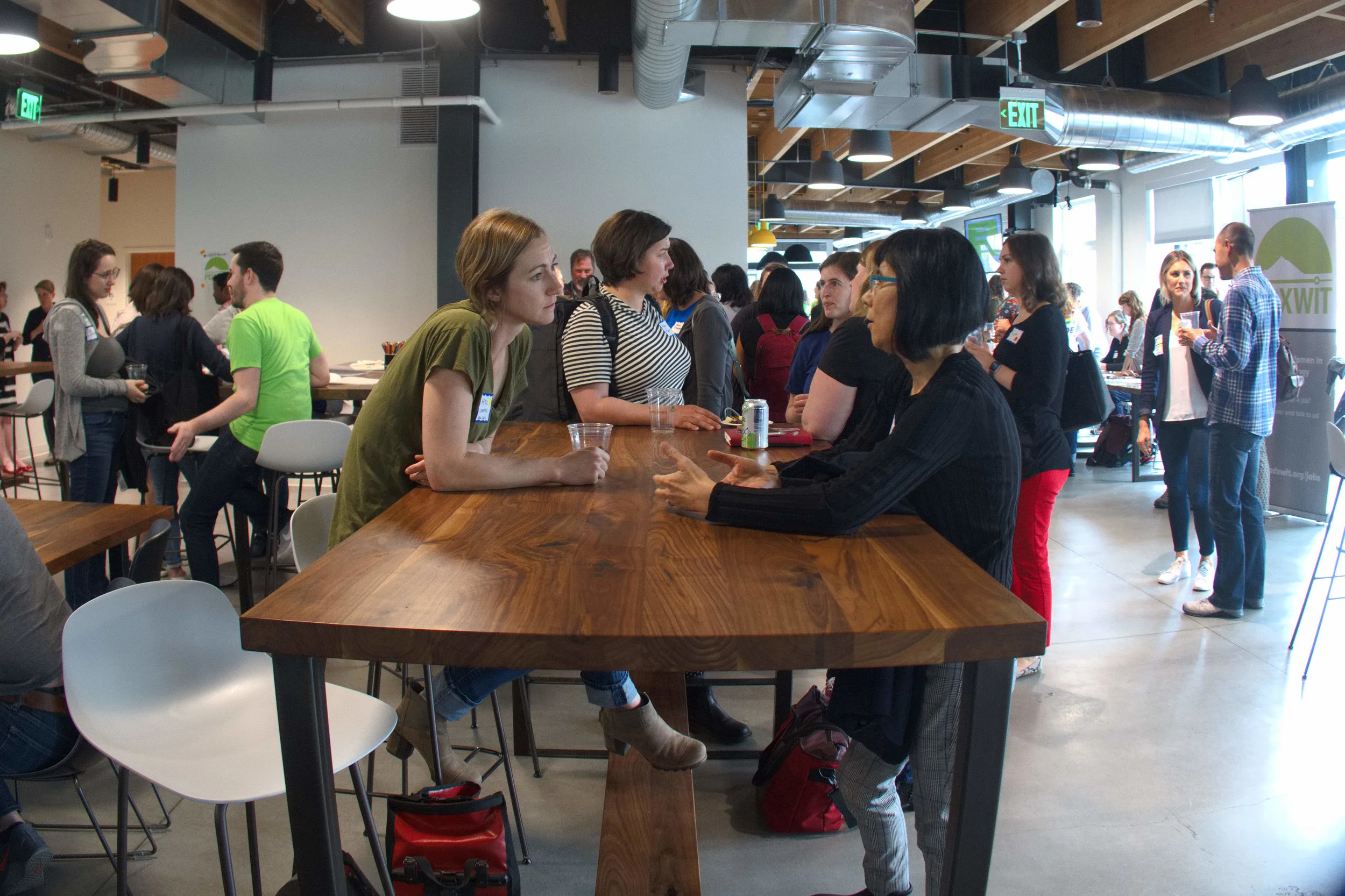 PDXWIT-May-Happy-Hour-Vacasa_2019-05-21_women-talking-at-tall-table.jpg