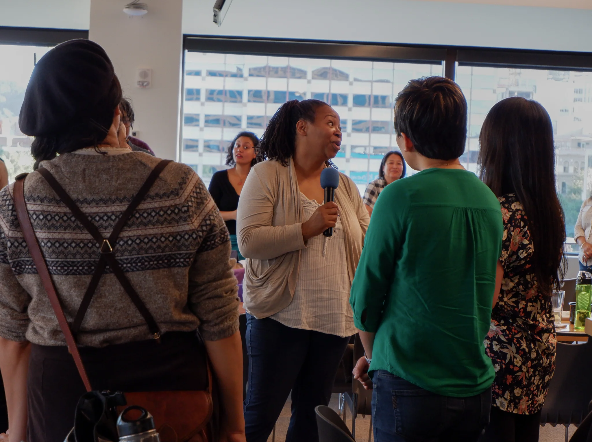 Attendee with microphone talking to group (1).jpg