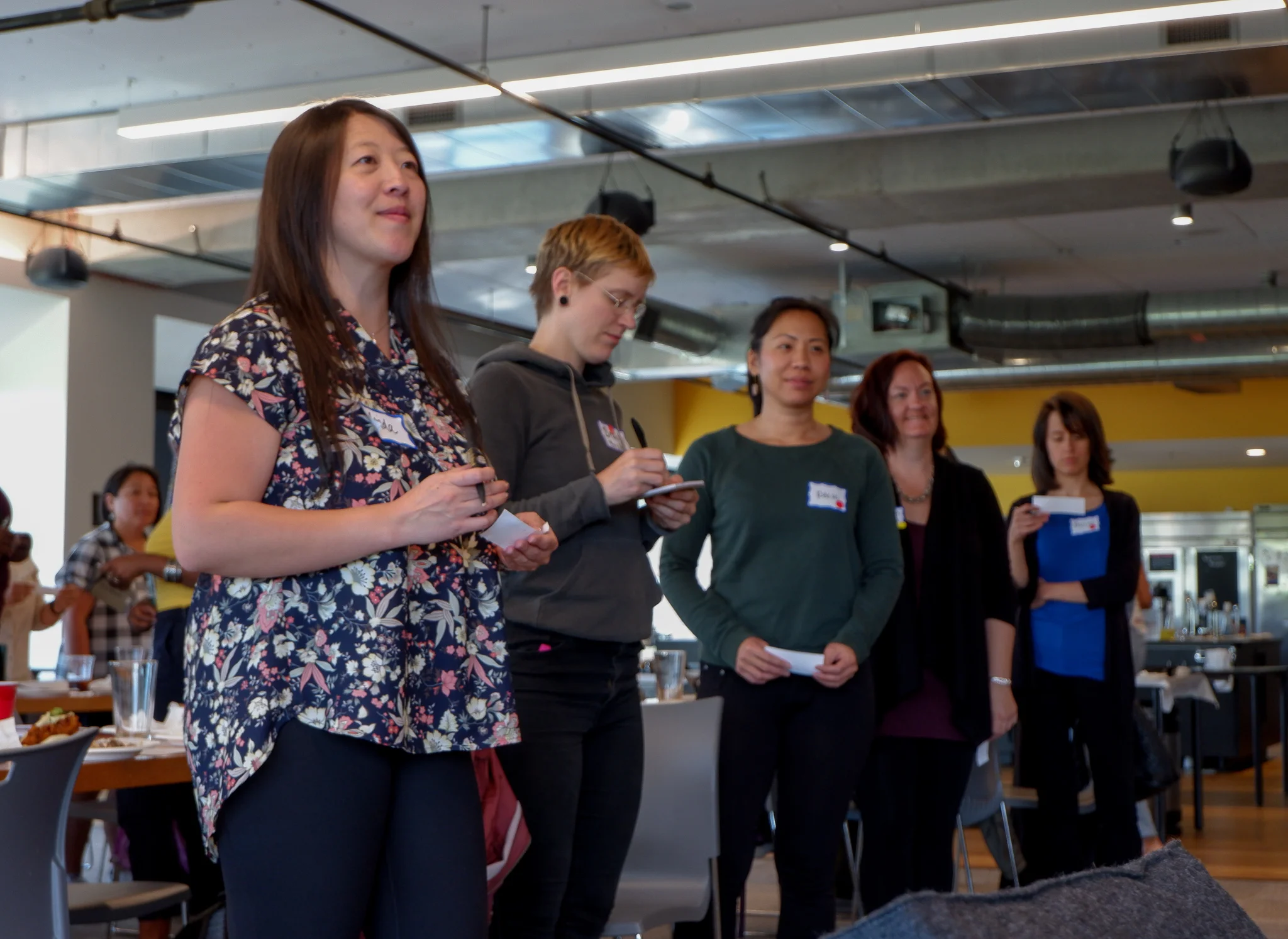 Women standing, looking at speaker .jpg
