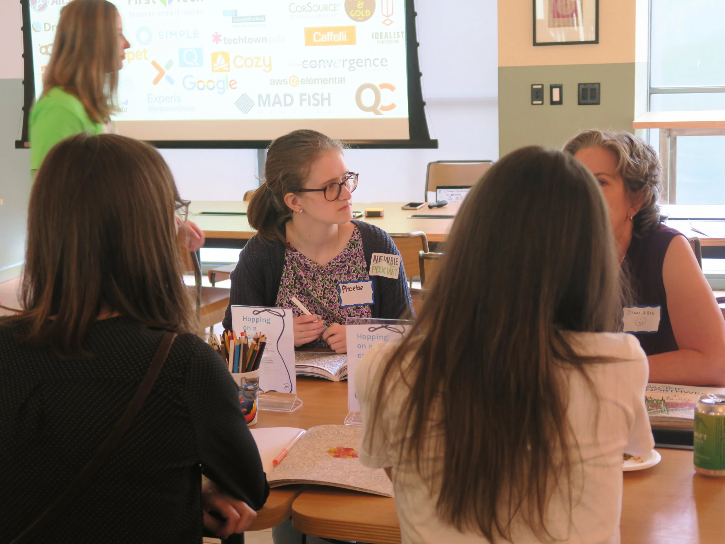 Woman intently listening at activity table.jpg