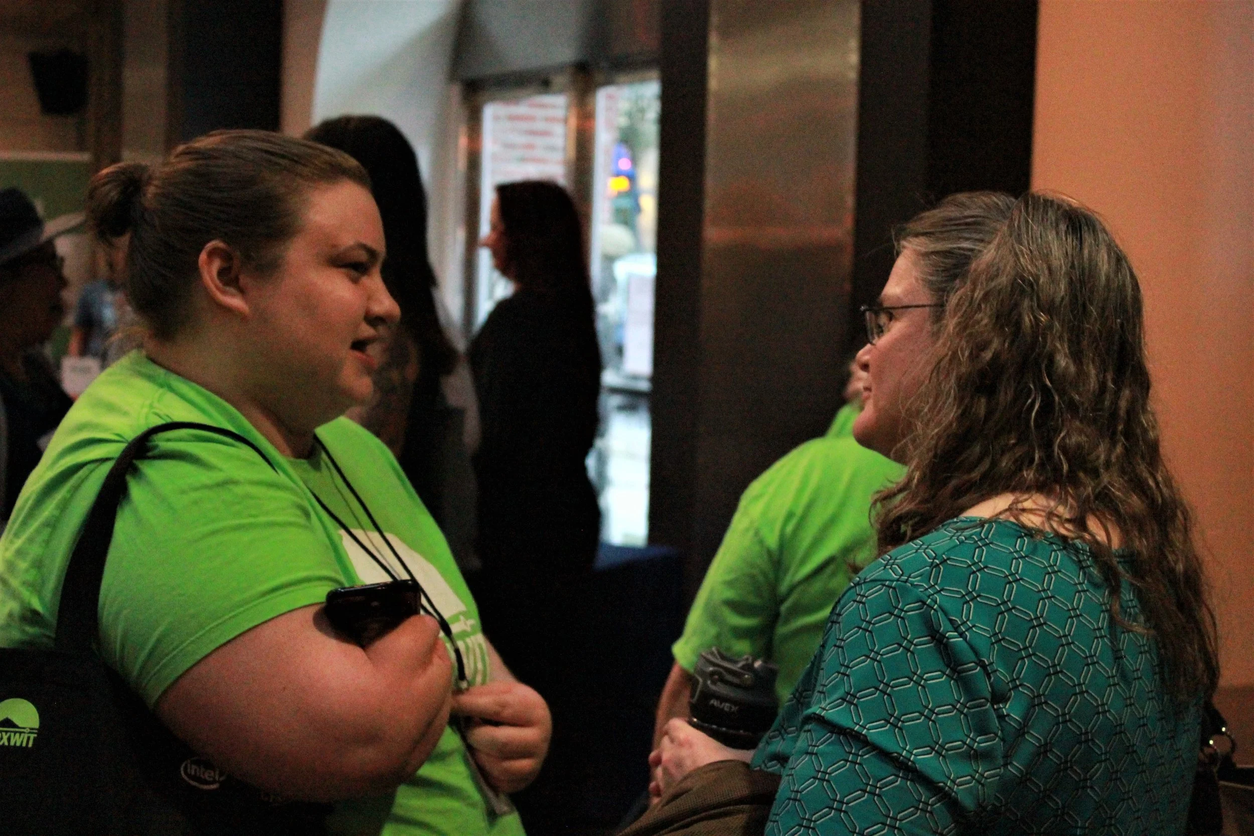 volunteers talking with attendee.jpg