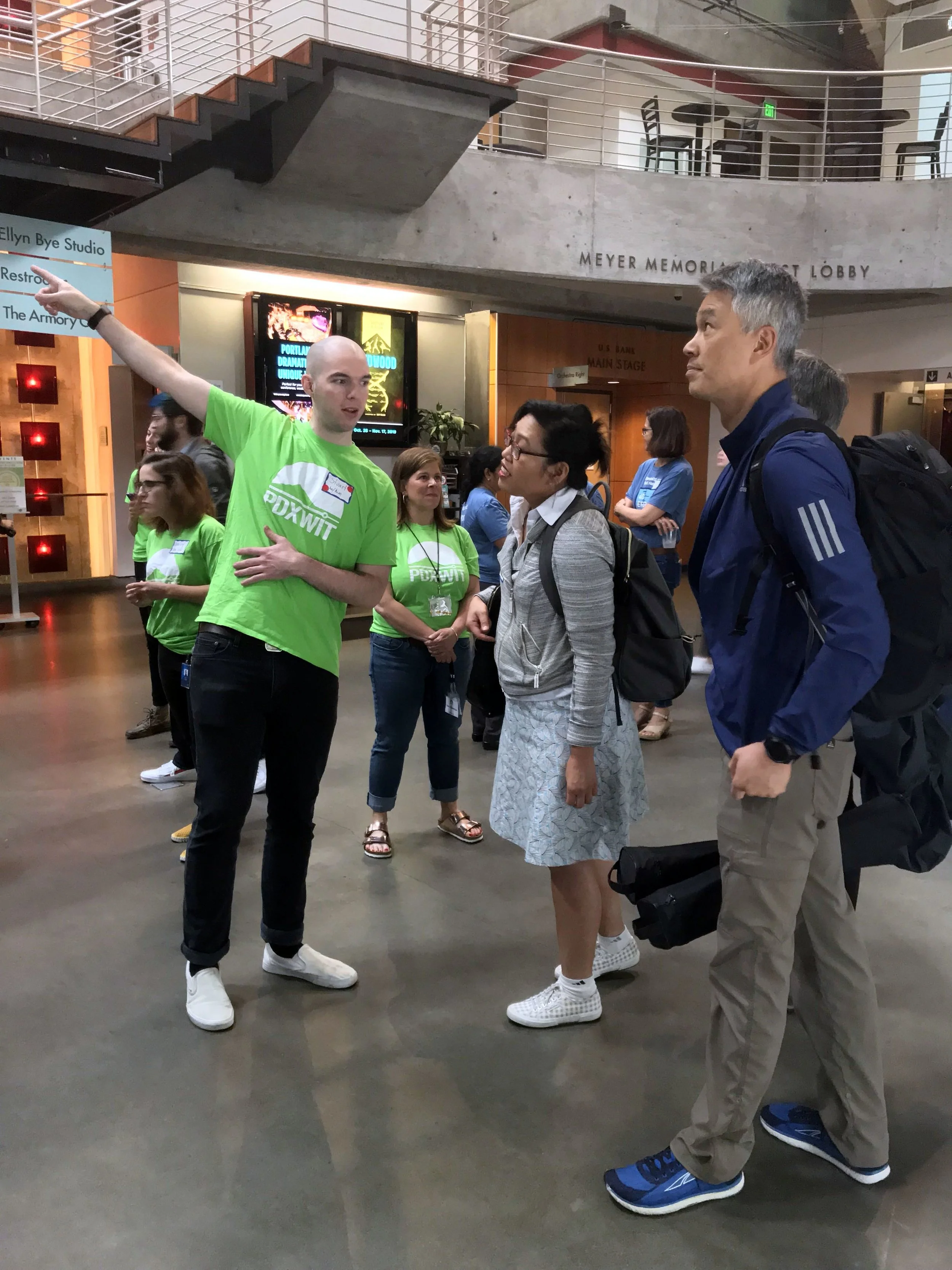 PDXWIT Volunteer directing Kiva to their table.jpg