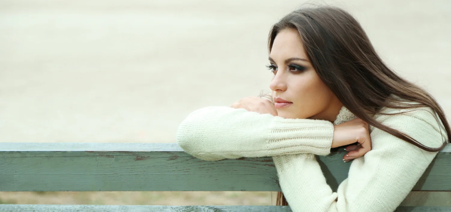 bigstock-Young-lonely-woman-on-bench-in-53107465.jpg