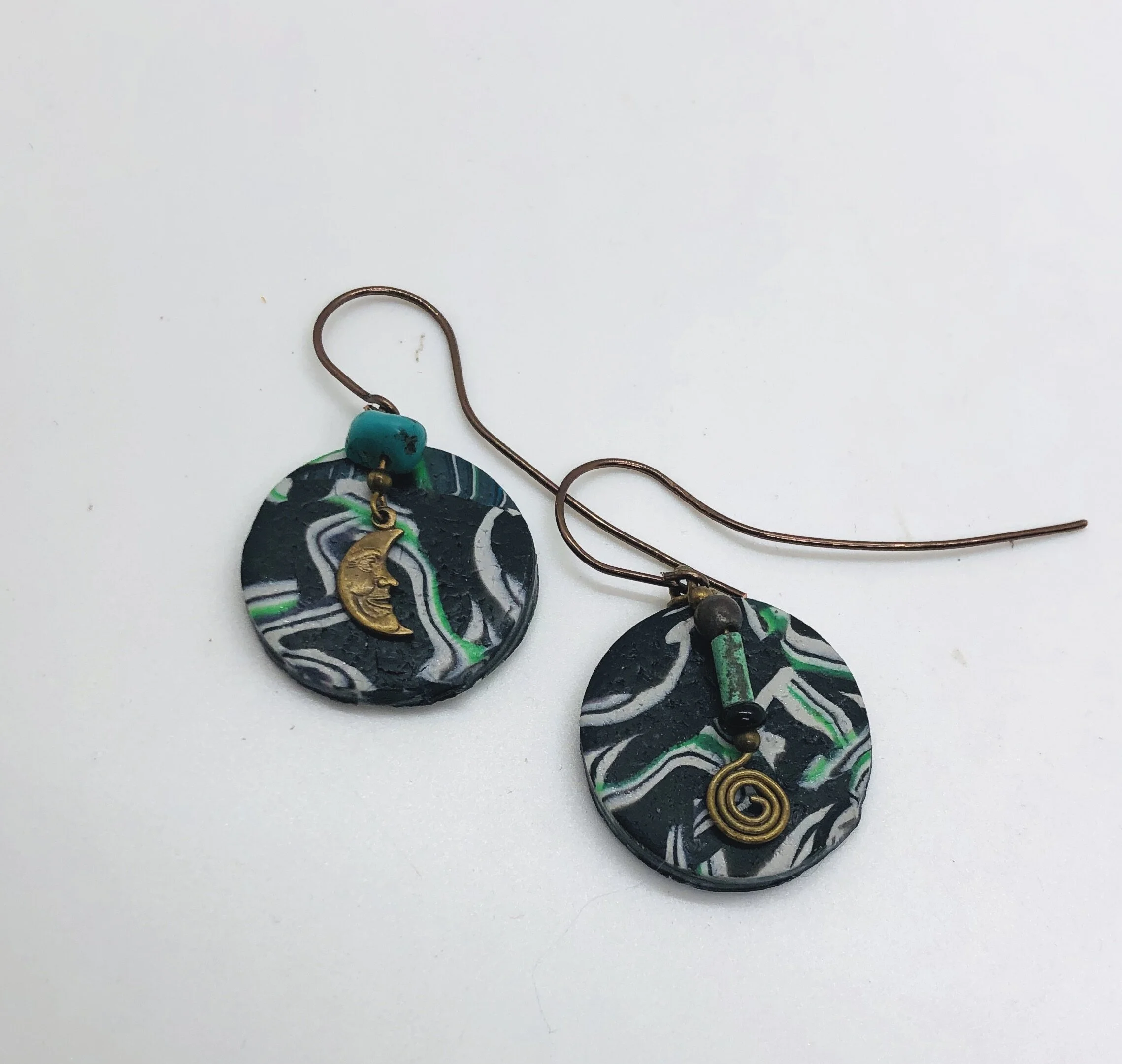 green disks with up cycled charms and artistic bronze wire