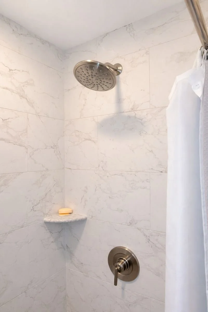Custom walk-in shower with MSI Praira Carrara matte wall tile and Moen Gibson shower fixtures