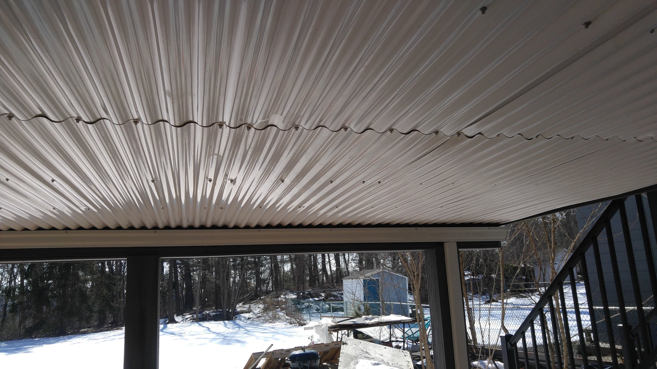 Underside of deck finished with white corrugated panels
