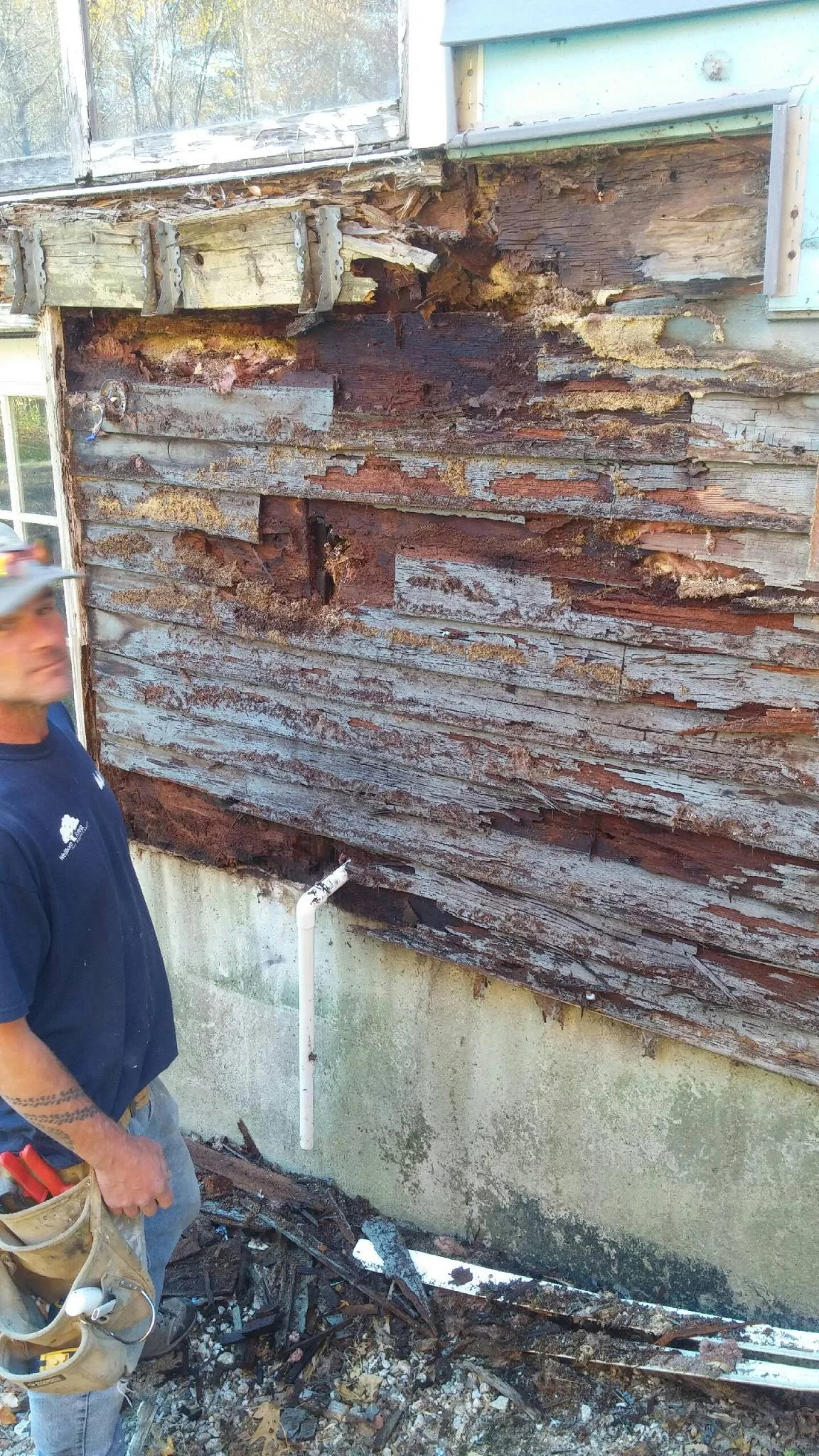 rot found under sliding door behind siding and repaired