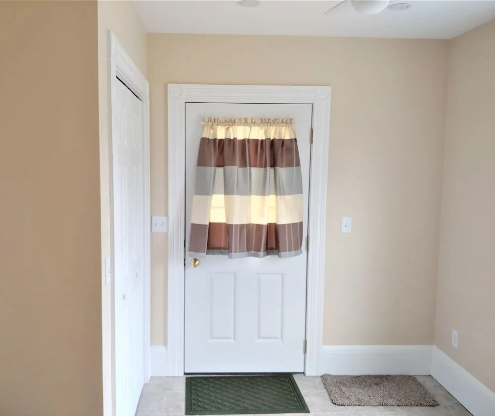 Mudroom entry door with trim and flooring in Hudson, MA