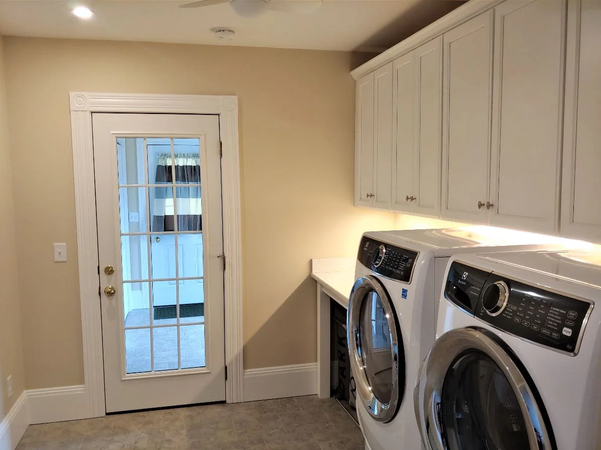 Laundry room addition with cabinetry and appliances in Hudson, MA