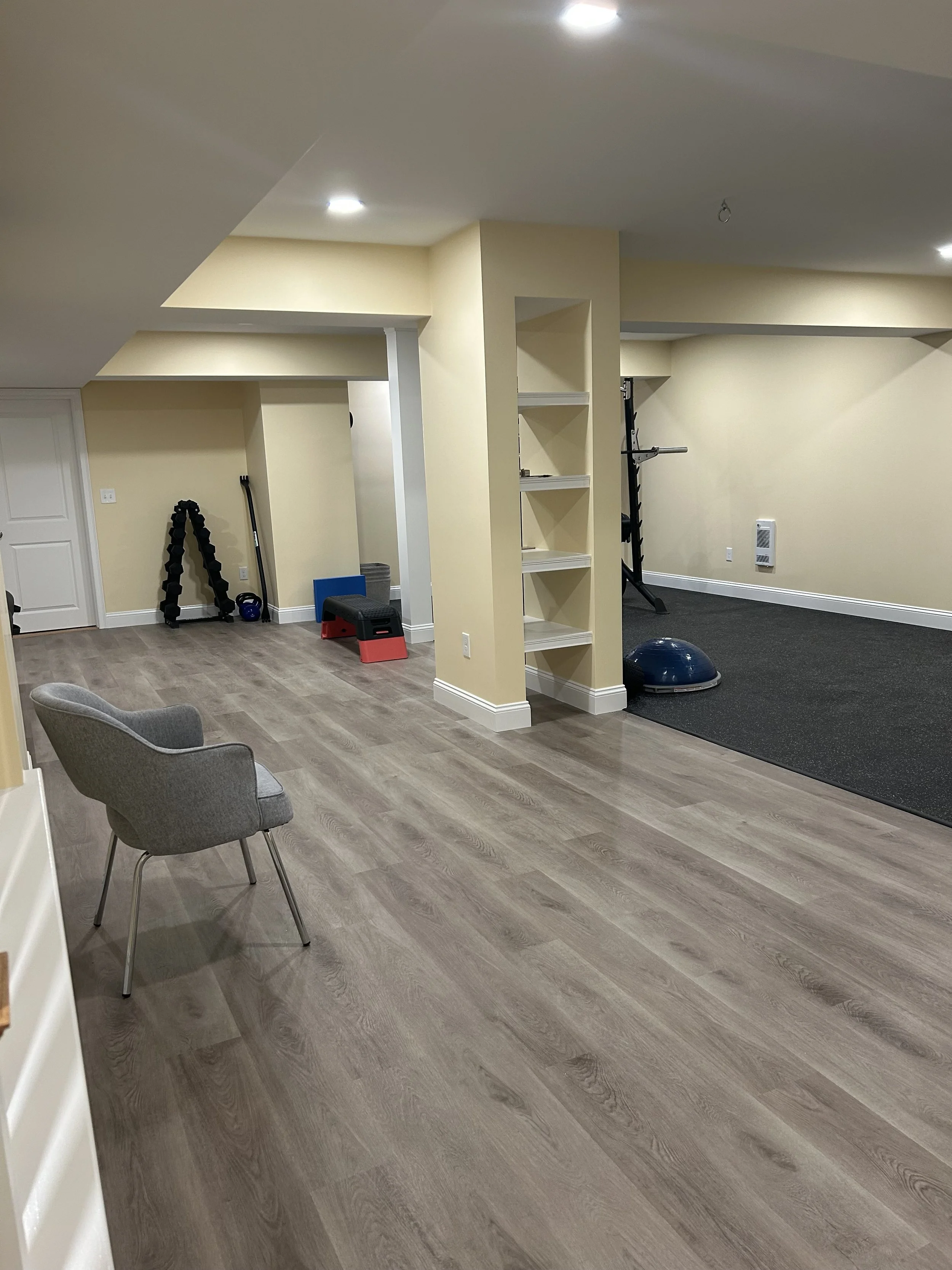 open-layout-basement-gym-with-lvt-flooring-core-remodeling.jpg