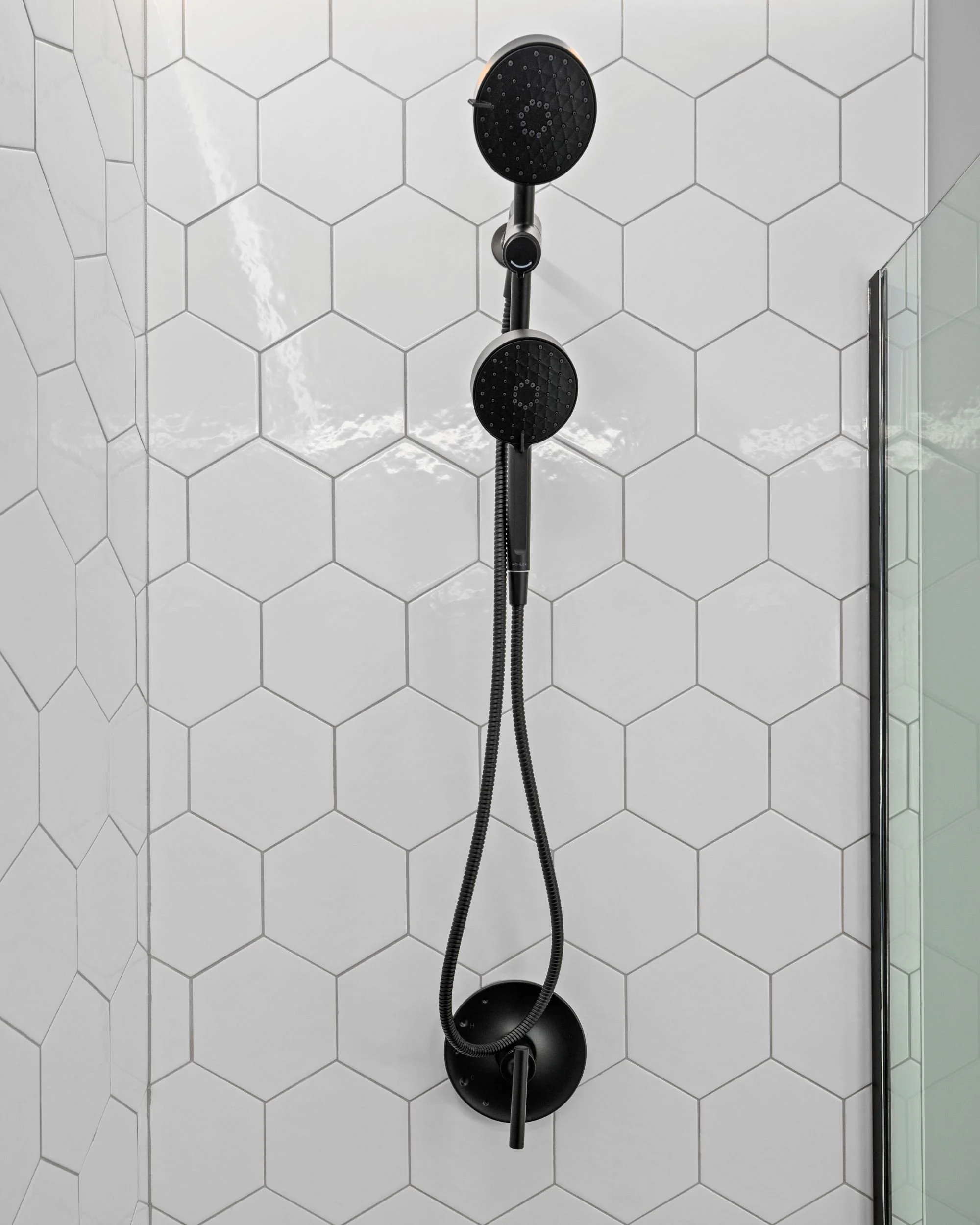 Kohler Awaken matte black shower system installed on white hex tile in a Boxborough MA master bathroom remodel