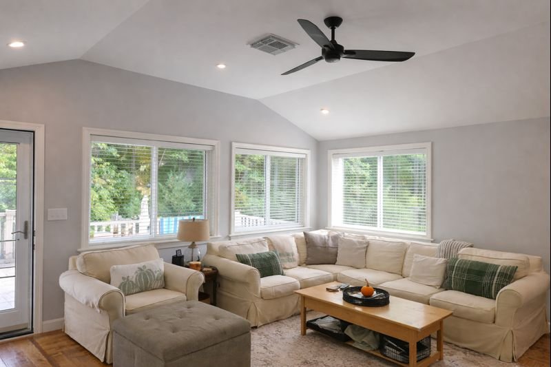 Finished family room addition interior with vaulted ceiling and multiple windows