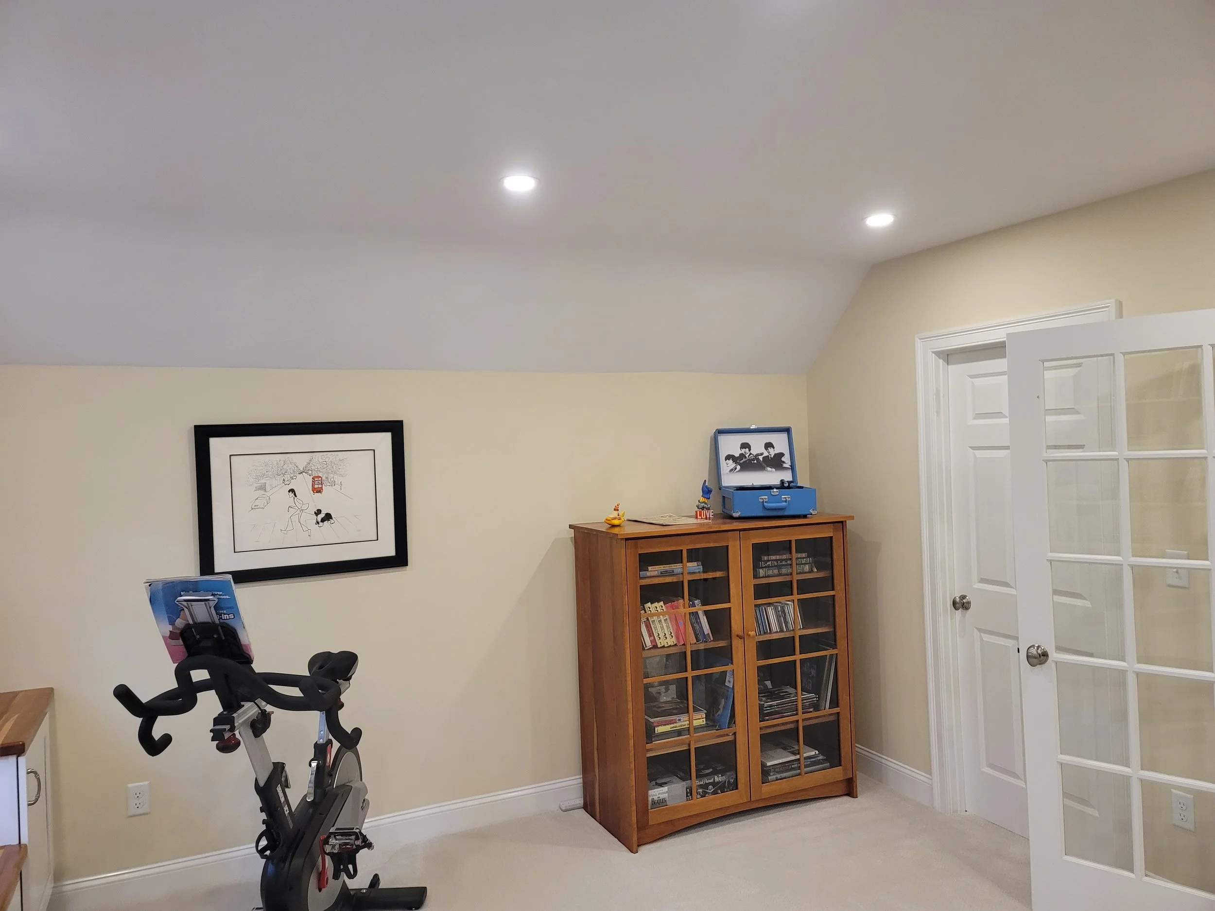 Bonus room in Stow MA used as a flexible living space with new carpet and French doors