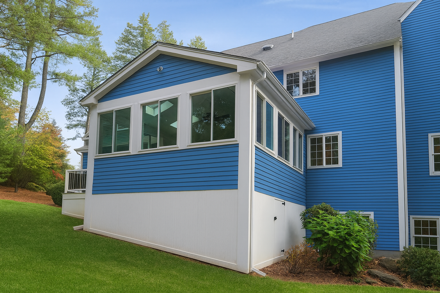 Side view of a 4-season room addition in Stow MA with ProVia windows and vaulted roofline