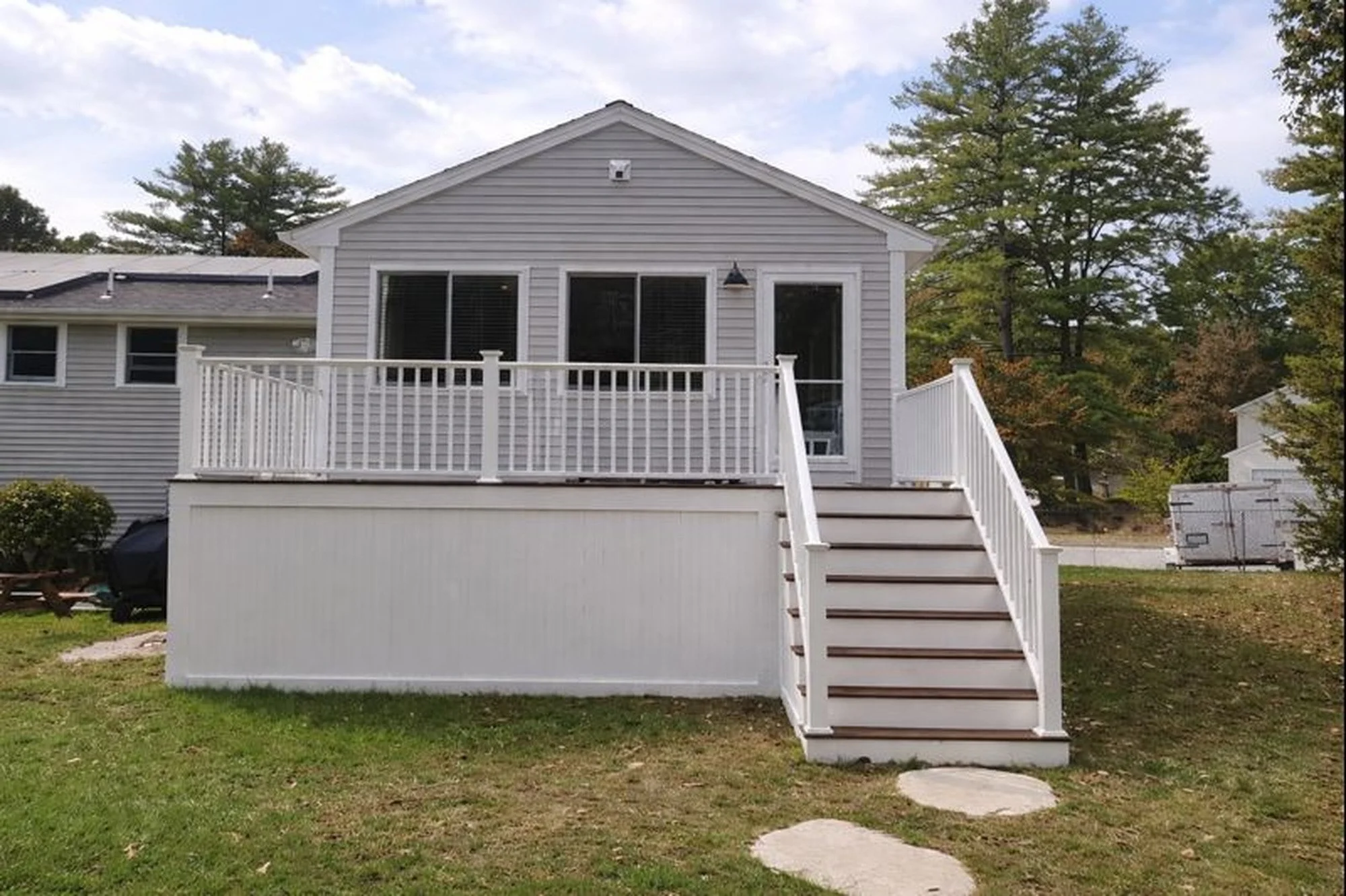 Full rear exterior view of family room addition with elevated deck and stair access
