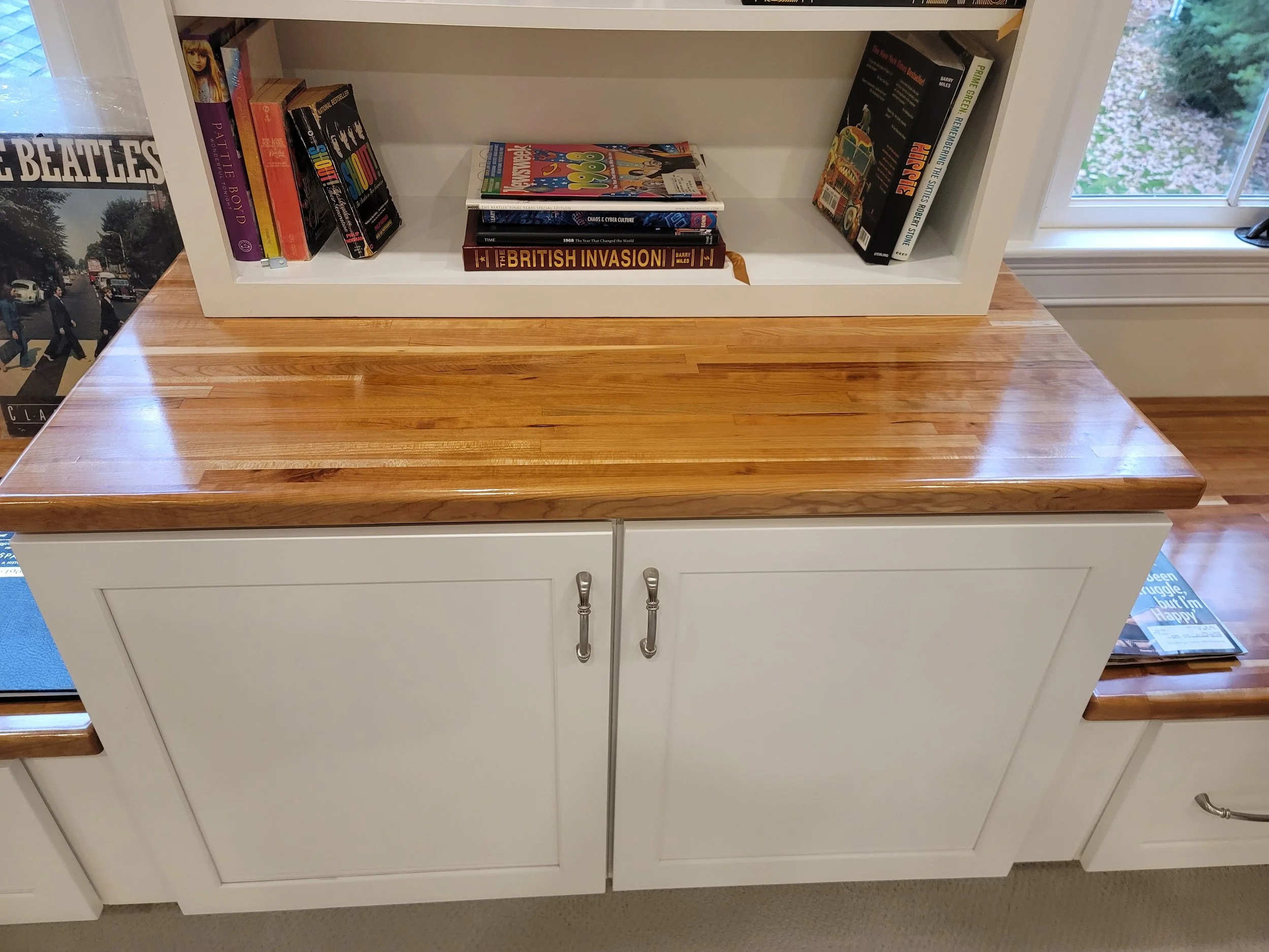 Custom cherry block window seating with storage in a bonus room in Stow MA